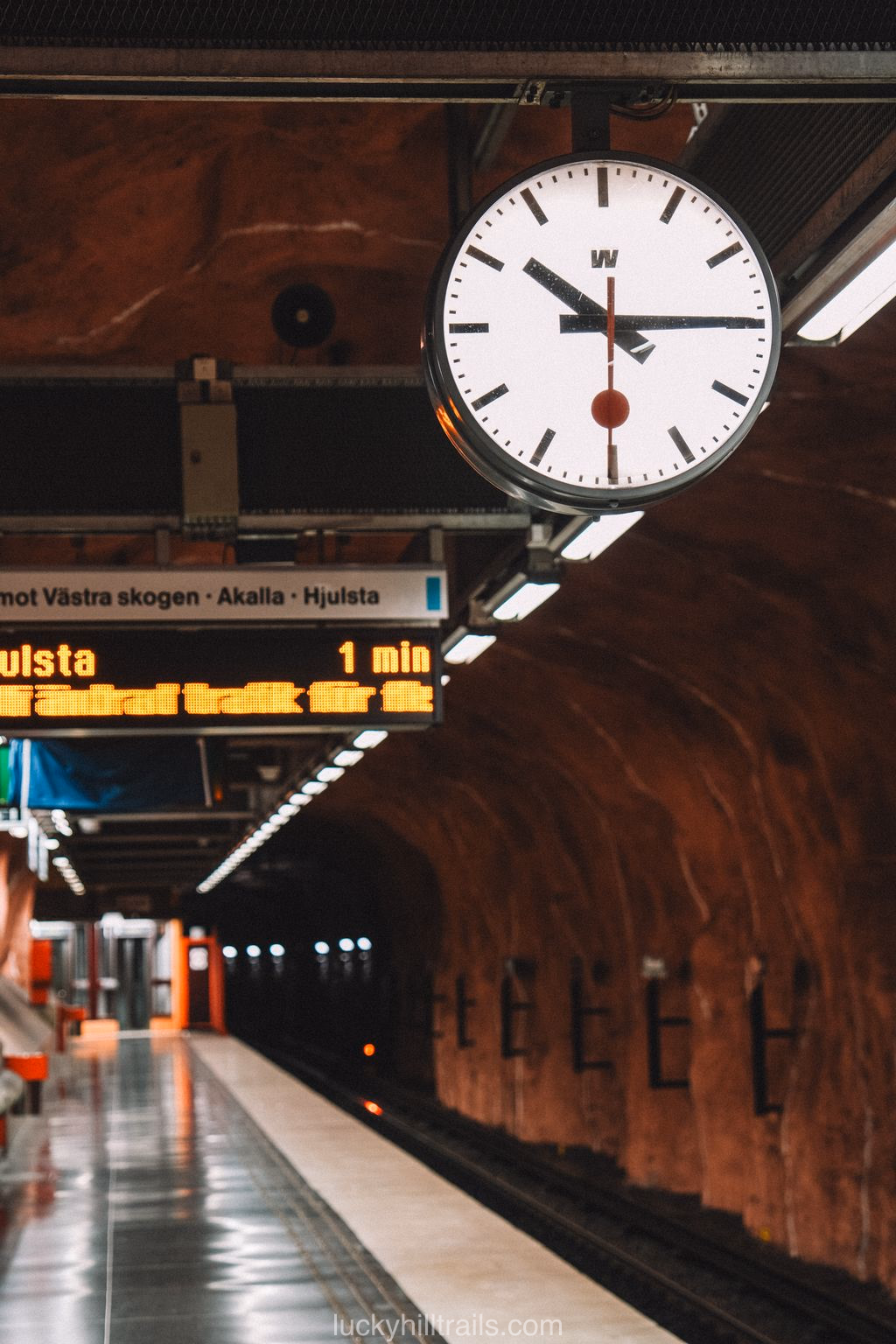 Red cave-style arches at Rådhuset station in the Stockholm metro