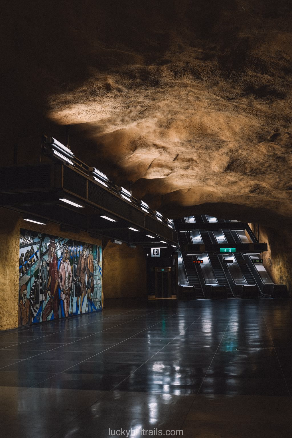 Olive-yellow walls and ceramic panels at Akalla station in Stockholm